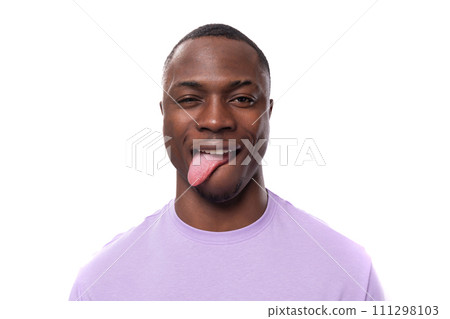 young excited american man with short haircut wearing lilac t-shirt makes a grimace 111298103