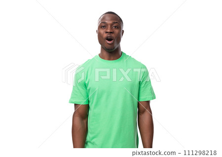 portrait of young surprised handsome american man in green t-shirt and jeans portrait of young surprised handsome american man in green t-shirt and jeans 111298218