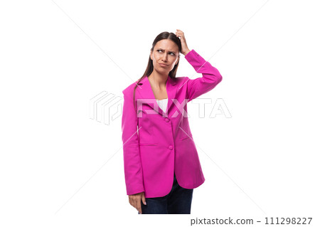 young pretty european woman with straight black hair is dressed in a pink jacket on a white 111298227