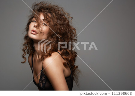 beautiful young woman with curly hair. pretty sexual girl 111298668