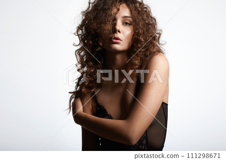 beautiful young woman with curly hair. pretty sexual girl in undewear 111298671
