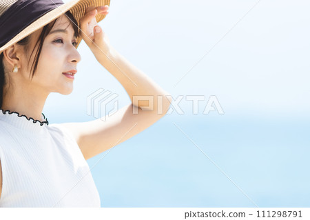 young woman wearing a straw hat 111298791