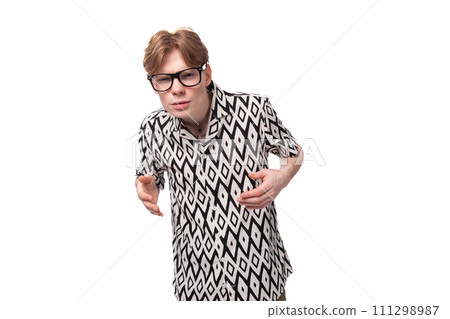 close-up of a young red-haired man in glasses with a tattoo on his arm trying to see the details in close-up of a young red-haired man in glasses with a tattoo on his arm trying to see the details in 111298987