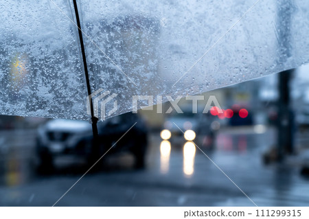 View through a plastic umbrella on a snowy evening Main road traffic b-1 View through a plastic umbrella on a snowy evening Main road traffic b-1 111299315