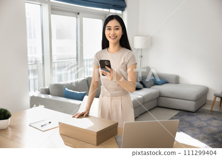 Happy beautiful Chinese webstore client girl using logistic application Happy beautiful Chinese webstore client girl using logistic application 111299404