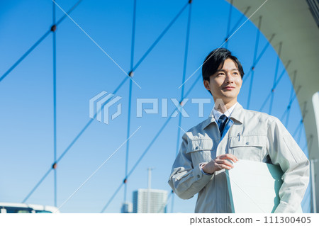 A man wearing work clothes A man wearing work clothes 111300405