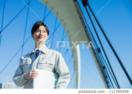 A man wearing work clothes A man wearing work clothes 111300406