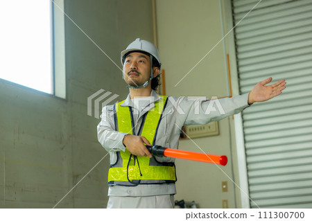 A man waving a guide rod A man waving a guide rod 111300700