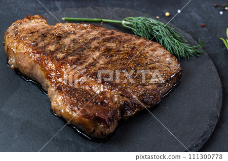 Grilled beef steak ribeye rare on on dark background 111300778