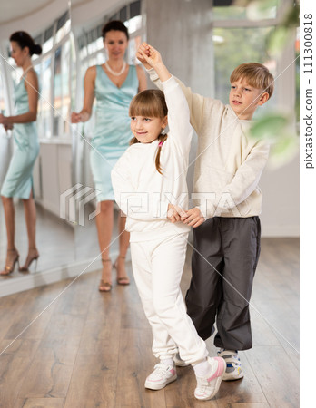 Tween dancers, girl and boy practicing waltz in dance studio Tween dancers, girl and boy practicing waltz in dance studio 111300818