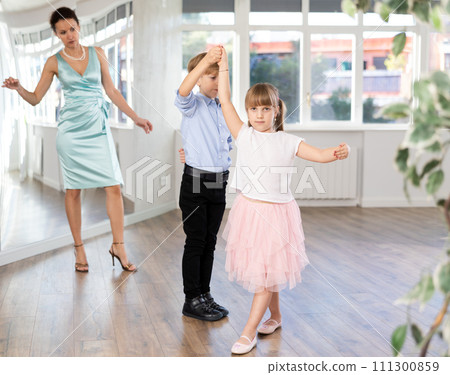 Boy and girl in pair train to dance contemporary vigorous hustle during classes. Boy and girl in pair train to dance contemporary vigorous hustle during classes. 111300859