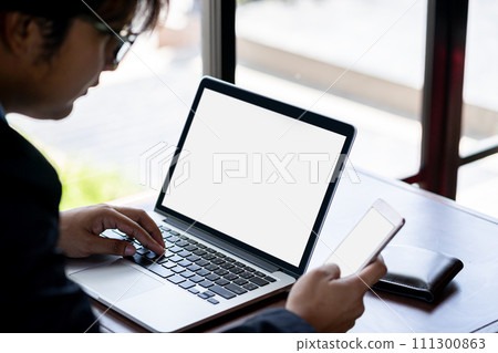 Businessman using smartphone to share internet for laptop to work in coffee shop 111300863