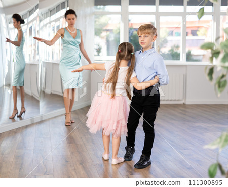 Boy and girl in pair train to dance contemporary vigorous hustle during classes. Boy and girl in pair train to dance contemporary vigorous hustle during classes. 111300895