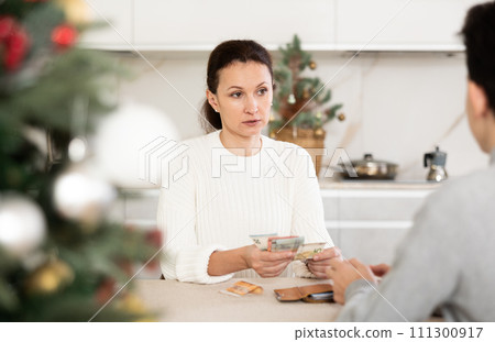 Son takes pocket money from mom before celebrating Christmas in room Son takes pocket money from mom before celebrating Christmas in room 111300917