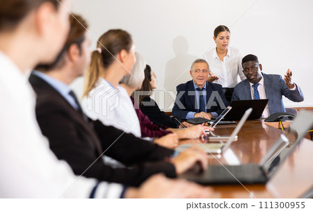 Company workers in meeting room during briefing 111300955
