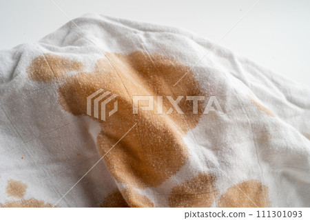 Dirty sauce stain on cloth to wash with washing powder, cleaning housework concept. Dirty sauce stain on cloth to wash with washing powder, cleaning housework concept. 111301093