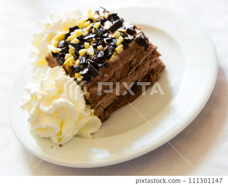 Chocolate cake with whipped cream Chocolate cake with whipped cream 111301147