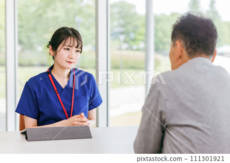 Female counselor/physical therapist who provides counseling/interview/examination (rehabilitation/nursing care/care plan) 111301921