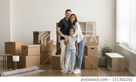 Happy parents and pretty kid girl moving into new house Happy parents and pretty kid girl moving into new house 111302202