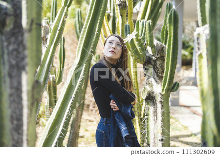 A woman strolling in the botanical garden A woman strolling in the botanical garden 111302609