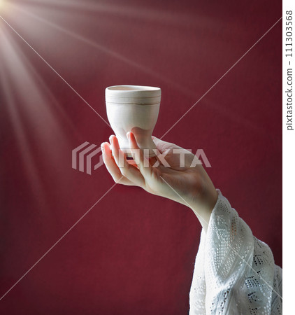 A hand in ancient clothing holds a clay bowl 111303568