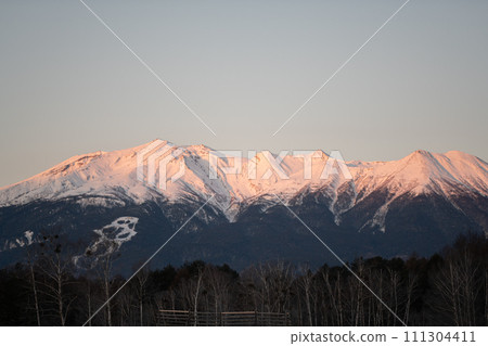 Snow-capped Mt. Ontake illuminated by the morning sun 111304411