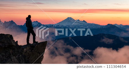 Adventure Hiker on Mountain Peak with Canadian Mountain Landscape in Background. 111304654