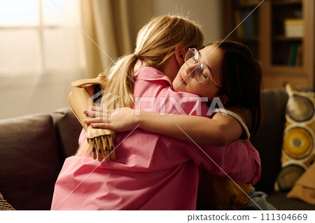 Mother and child embracing on couch Mother and child embracing on couch 111304669