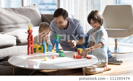 Loving father play wooden bricks with cute little kids 111305474