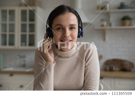 Attractive young woman in headphones take part in videoconference 111305509