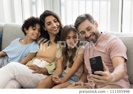 Cheerful parents and cute happy kids taking selfie Cheerful parents and cute happy kids taking selfie 111305996