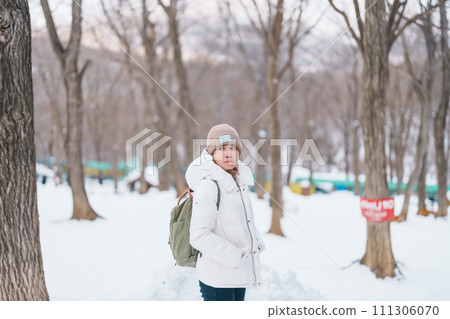 Woman tourist with snow in winter season at Zao fox village, traveler sightseeing Miyagi prefecture. landmark and popular for attraction near Sendai, Tohoku, Japan. Travel and Vacation 111306070