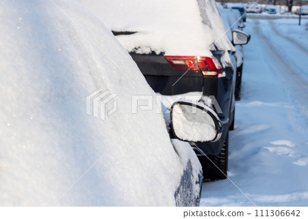 Line of Cars Covered in Snow on a Street Line of Cars Covered in Snow on a Street 111306642