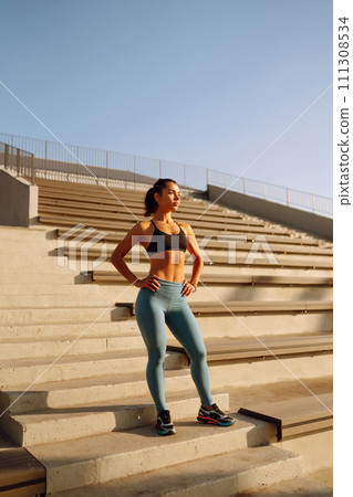 Fit Young woman in sportswear doing yoga, fitness exercise on the street. Sport, Active life. 111308534