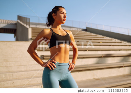 Fit Young woman in sportswear doing yoga, fitness exercise on the street. Sport, Active life. Fit Young woman in sportswear doing yoga, fitness exercise on the street. Sport, Active life. 111308535