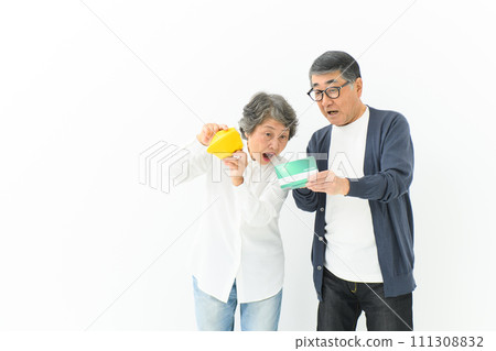 Senior couple worried about their bankbook and wallet Senior couple worried about their bankbook and wallet 111308832