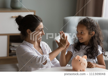 Mom teach daughter save money giving high five feel happy 111309048