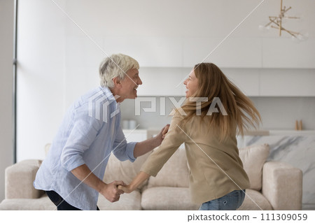 Joyful excited adult and senior father training energetic social dance Joyful excited adult and senior father training energetic social dance 111309059