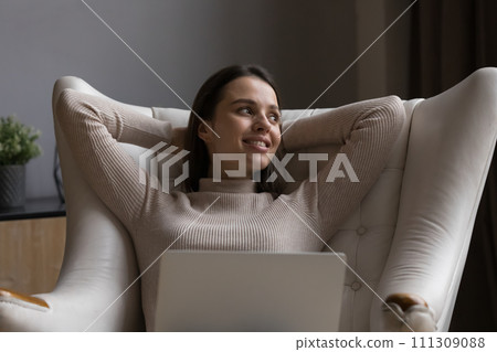 Freelancer woman relax on armchair take break from laptop work Freelancer woman relax on armchair take break from laptop work 111309088