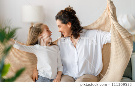 Happy mother and her daughter are playing 111309553
