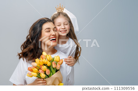 Daughter and mother with bouquet of flowers Daughter and mother with bouquet of flowers 111309556