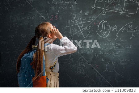 Kid in class on background of blackboard 111309828
