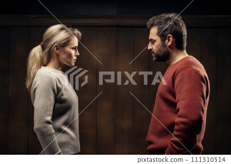 Husband and wife quarrel and look at each other with angry looks 111310514