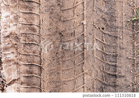 Car tread on the sand. Tread marks from car wheels on a dirt road made of sand. View from above. Car tread on the sand. Tread marks from car wheels on a dirt road made of sand. View from above. 111310818