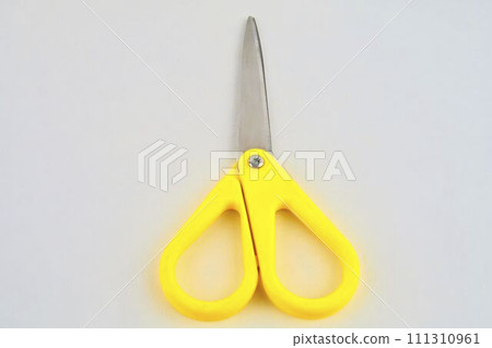 Yellow scissors isolated on a white background. Flat design. Top view 111310961