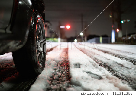Snowy intersection and car tires Snowy intersection and car tires 111311393