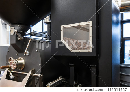 Black industrial coffee roaster close-up photo Black industrial coffee roaster close-up photo 111311737