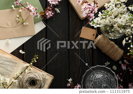 Spring twigs with flowers in a jar, on a dark wooden background. Spring twigs with flowers in a jar, on a dark wooden background. 111311975