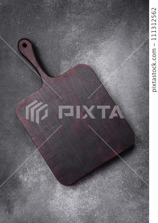Empty wooden cutting board on a light texture background 111312562