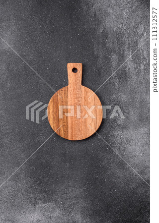 Empty wooden cutting board on a light texture background 111312577